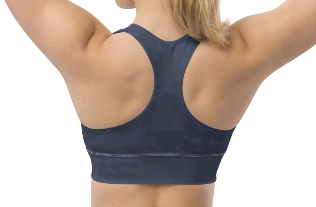 Back view of a woman wearing the Urban Gray Camo Pickleball Longline Sports Bra, emphasizing the racerback design, longline cut, and dark gray camouflage pattern.