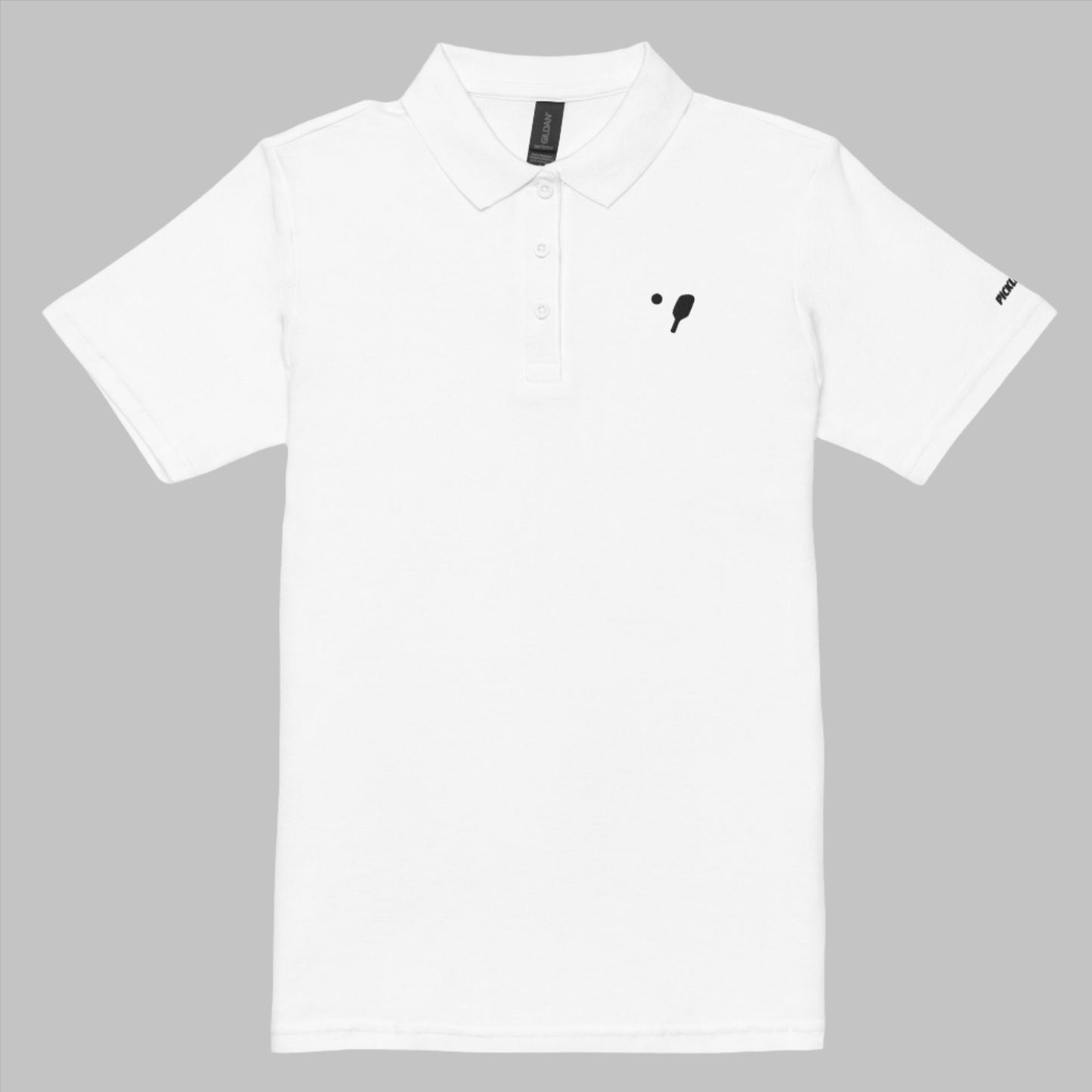 Front view of a white women's pique polo shirt featuring a black embroidery badge of a pickleball paddle on the left chest and the logo on the right sleeve, designed by OOKAMI SPORTS.