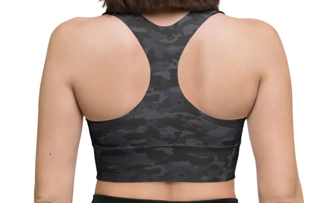 Back view of a woman wearing the Stealth Camo Pickleball Longline Sports Bra, showcasing the racerback design, longline cut, and camouflage pattern.