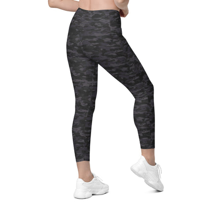 Woman wearing Stealth Camo Pickleball High-Waisted Crossover Leggings in a dark camouflage pattern, displaying the back view with a flattering cut, high-waisted fit, and ankle-length style.