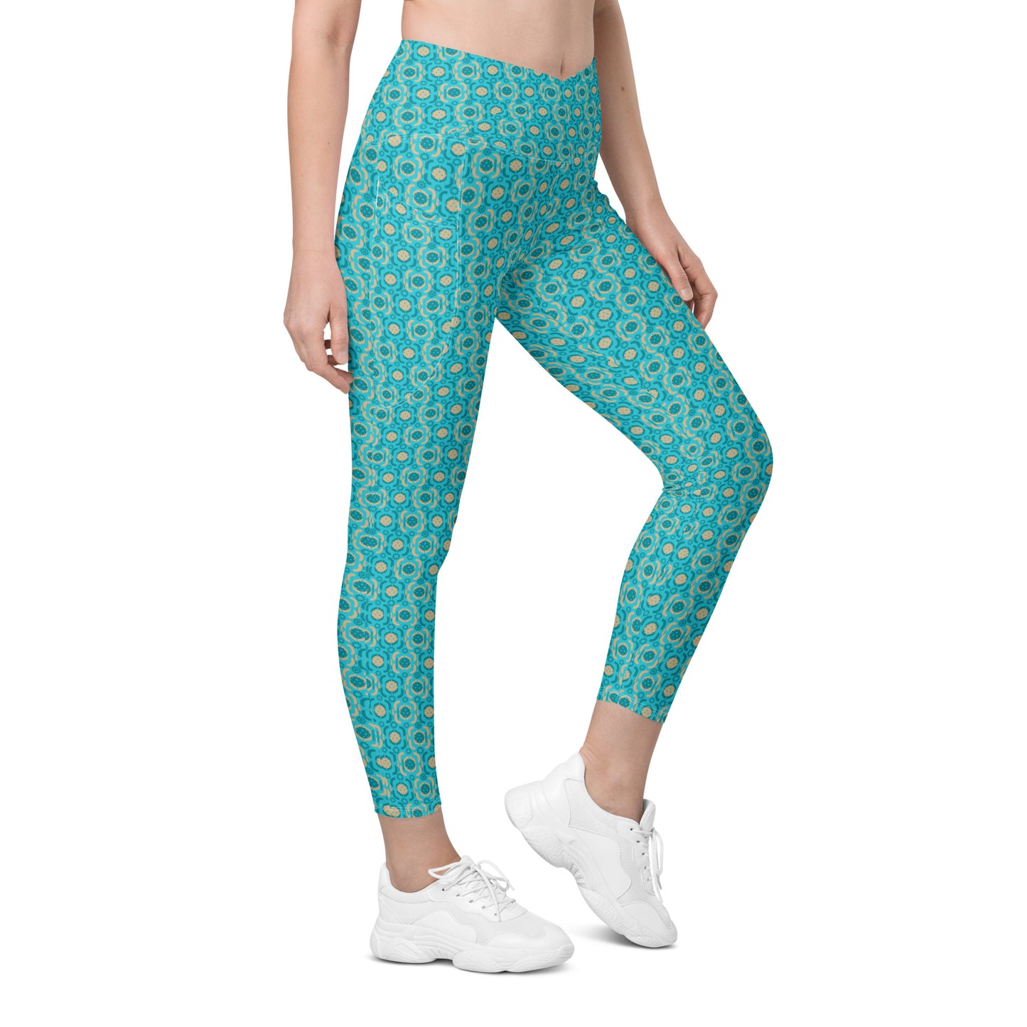  Trendy turquoise geometric print leggings with a high waist and side pockets, displayed from the right side. Great for gym sessions or pickleball matches.