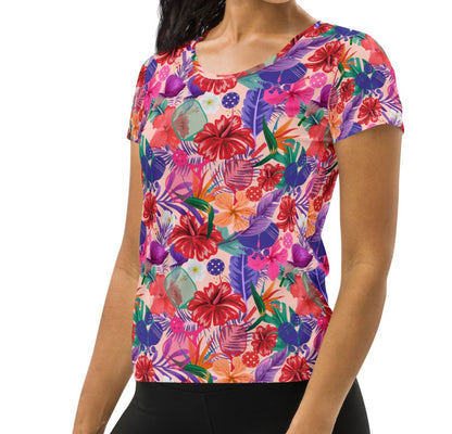 Side view of a woman in a Tropical Oasis Pickleball Performance Shirt by OOKAMI SPORTS. The shirt showcases a colorful floral pattern, ideal for stylish sports fashion.