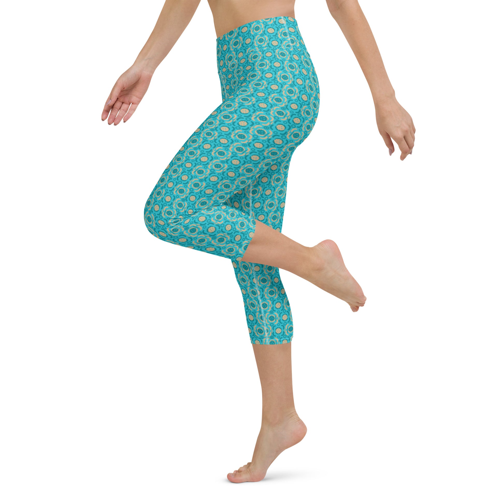 Model lifting her leg in Turquoise Tranquility Pickleball Yoga Capri Leggings, emphasizing the leggings' stretchability and athletic functionality.