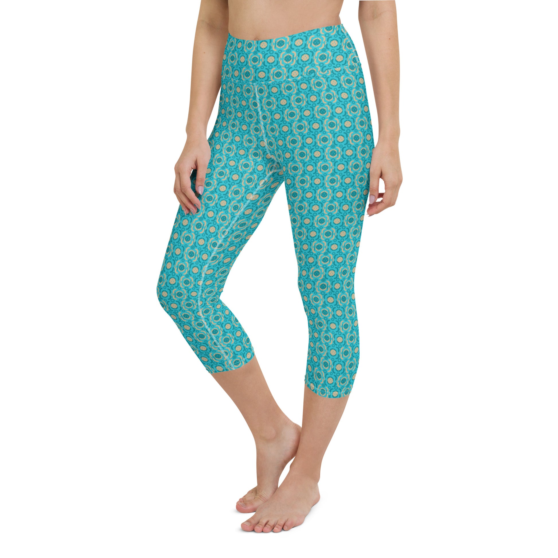 Full-length view of Turquoise Tranquility Yoga Capri Leggings on a model standing straight, showcasing the leggings' vibrant color and sporty pickleball pattern.