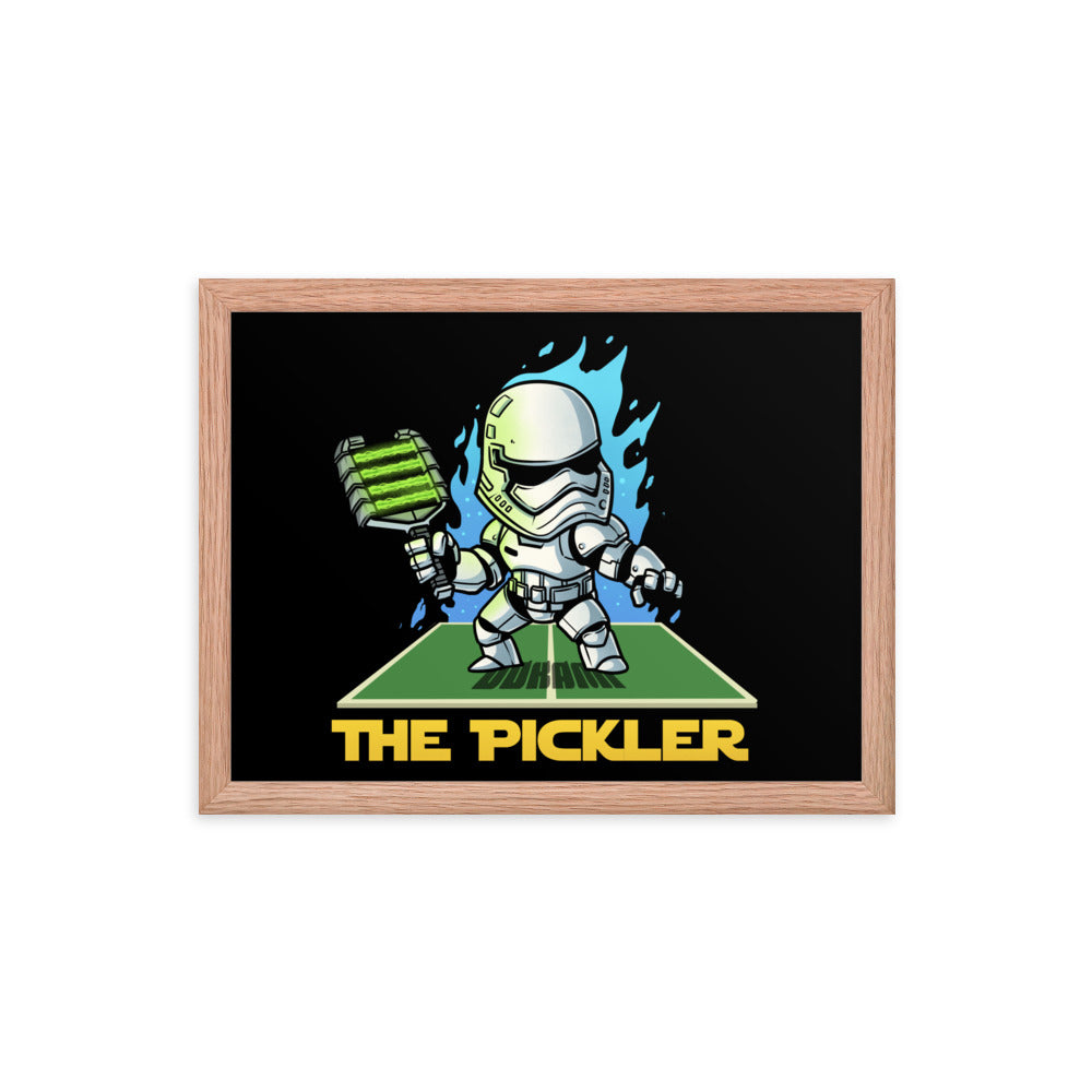 12x16 inch framed poster of 'THE PICKLER' featuring a stormtrooper-themed character in a dynamic pose with a pickleball paddle, encased in a red oak frame.