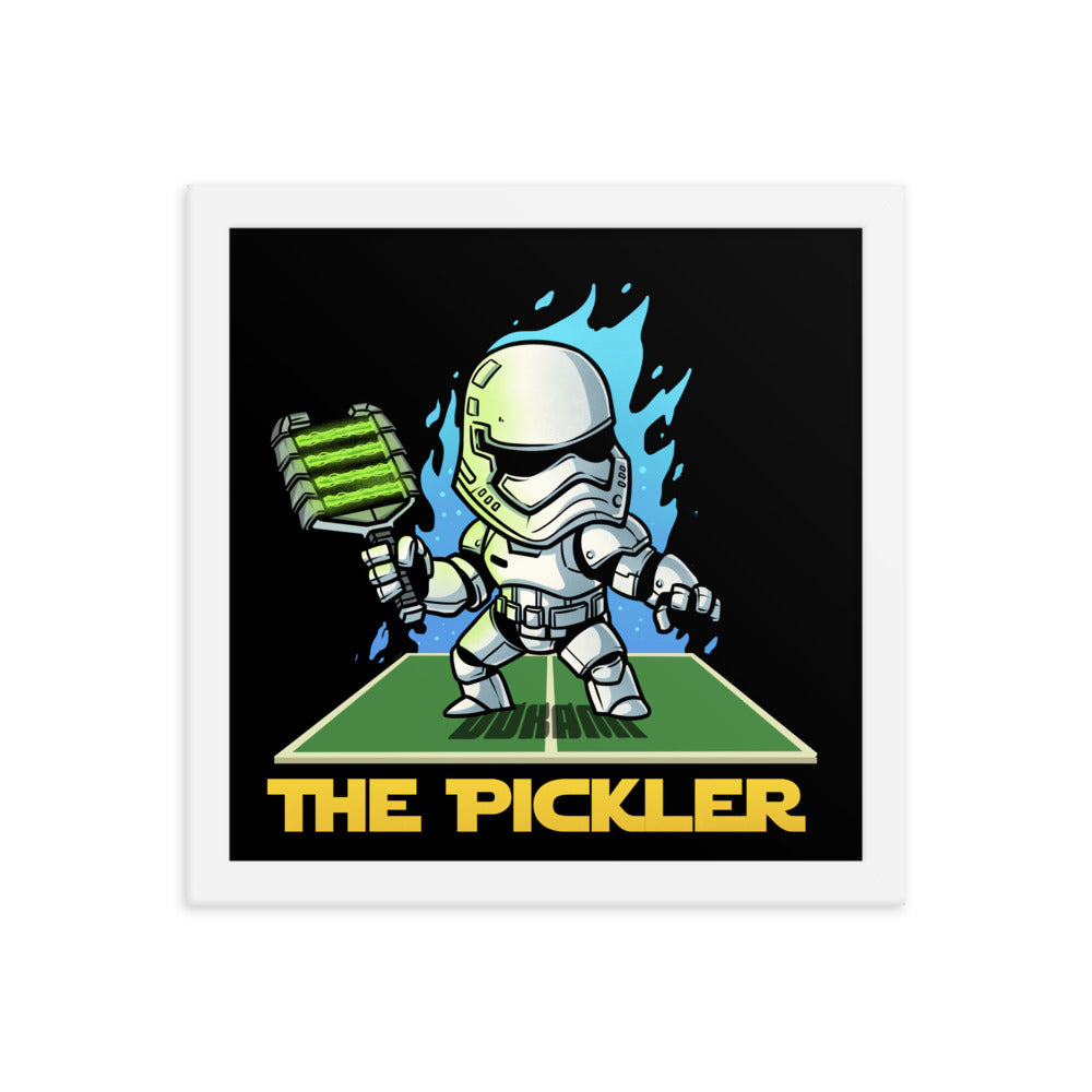  (12x12 inches): "Square framed poster featuring 'The Pickler', a stormtrooper-themed character, wielding a pickleball paddle with energetic blue flames around, set in a white frame.