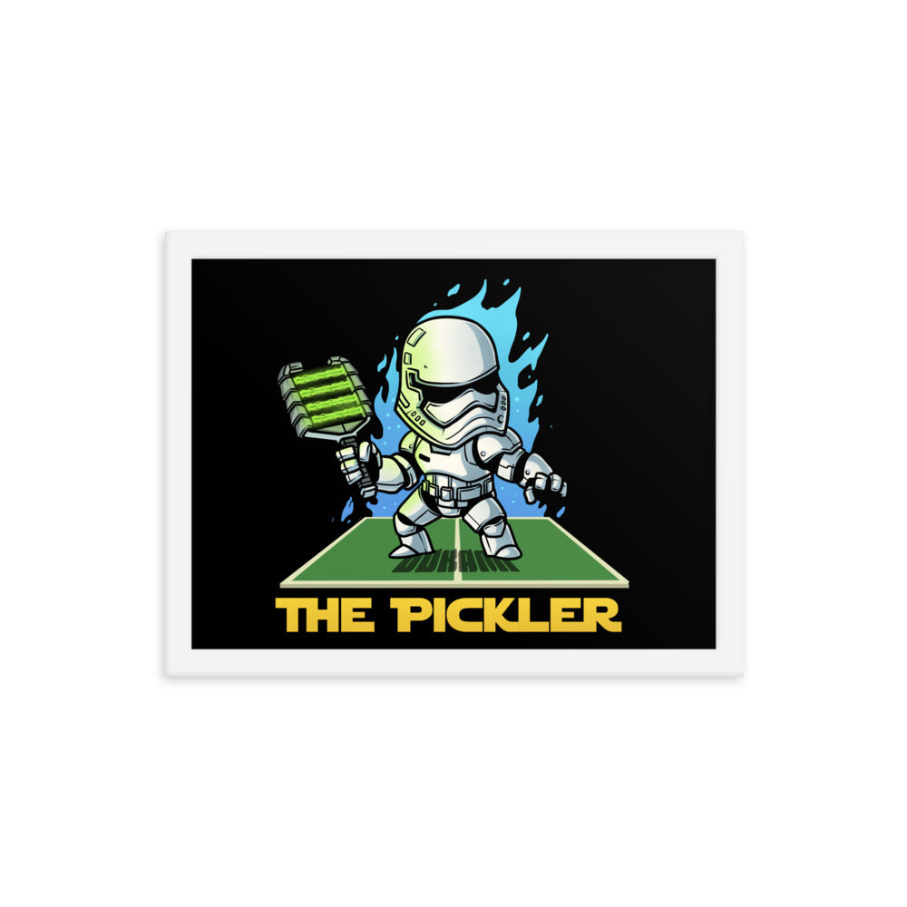  (12x16 inches): "Rectangular framed poster showing 'The Pickler' in action, a character inspired by stormtroopers, holding a paddle on a pickleball court. The poster is encased in a white frame.