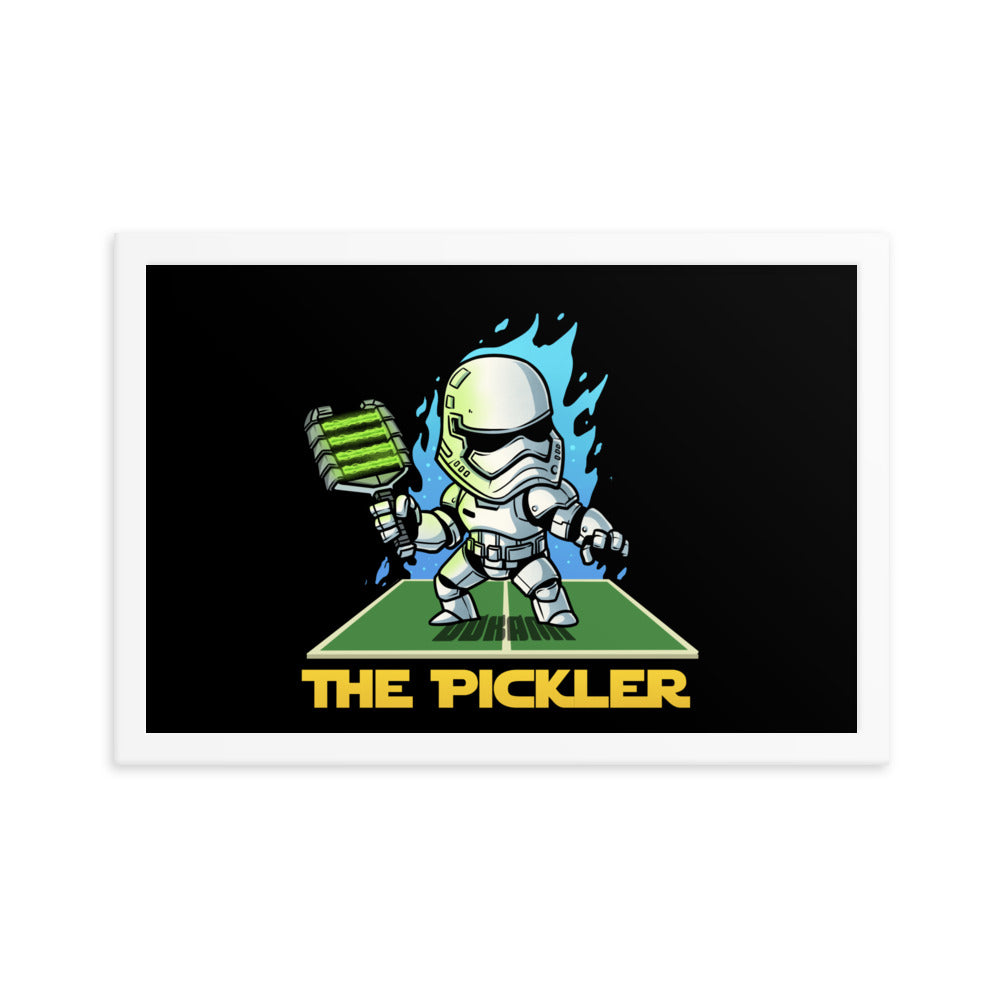 (12x18 inches): "Vertical framed poster of 'The Pickler', a stormtrooper-like figure with a pickleball paddle, posed dynamically on a green court, framed in white.