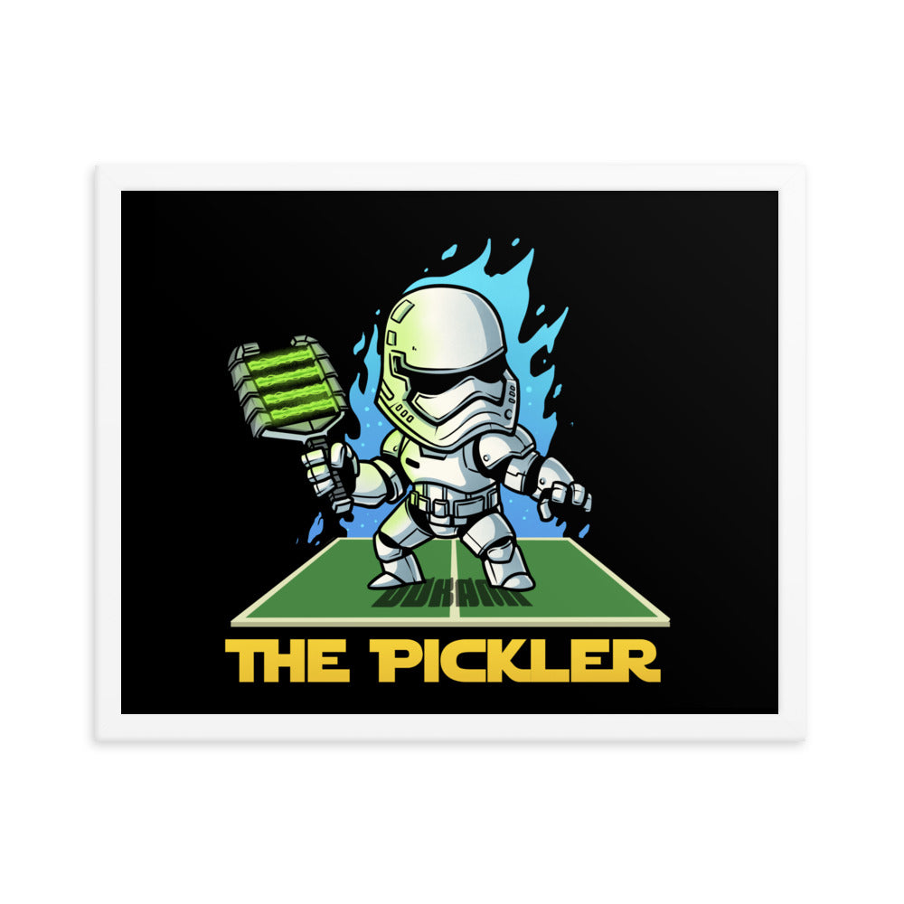  (16x20 inches): "Poster in a white frame showcasing 'The Pickler', a character in stormtrooper armor holding a pickleball paddle, on a pickleball court with blue fiery effects in the backdrop."