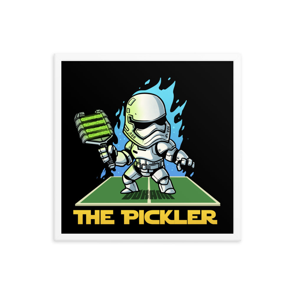 18x18 Framed poster depicting 'The Pickler,' a character modeled after a stormtrooper, in a dynamic pose with a green pickleball paddle. The character stands prominently against a black backdrop with bold blue decorative elements and is positioned on a green base labeled 'THE PICKLER' in bold yellow text.