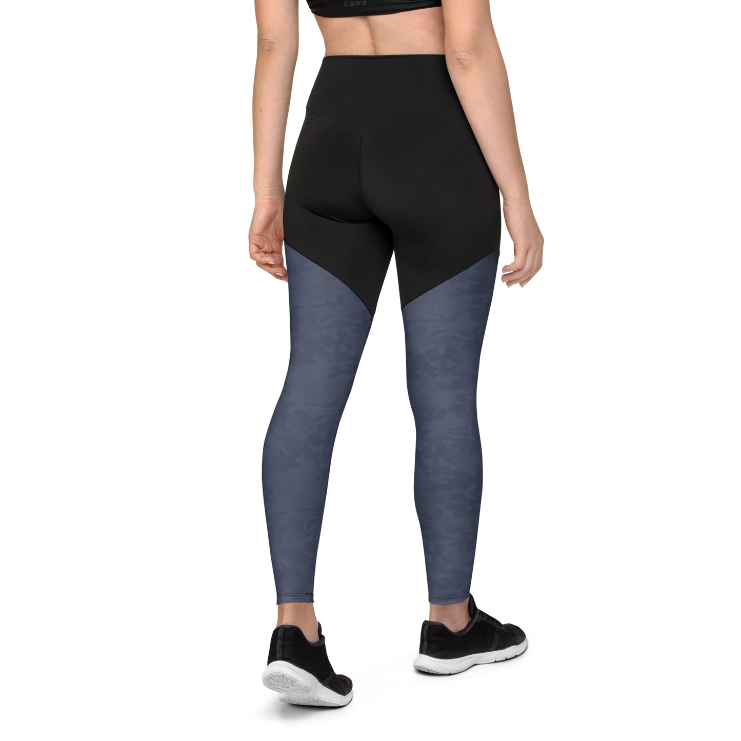  Back view of a woman wearing Urban Gray Camo Pickleball Sports Leggings, emphasizing the high-waisted design, double-layered belt, and urban gray camouflage print on the lower legs.