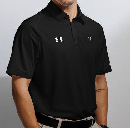 Close-up of a man wearing a black Under Armour® polo shirt featuring the Under Armour logo on the left chest and the OOKAMI SPORTS pickleball symbol on the right chest, designed for optimal performance and comfort.