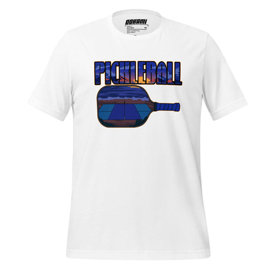 Front view of white t-shirt featuring a sunset over a pickleball court graphic reflected in a paddle with the text 'PICKLEBALL.