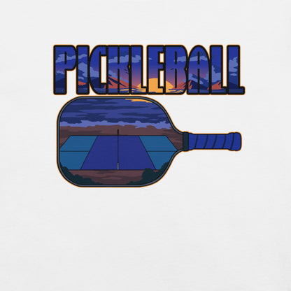 Close-up view of the sunset over a pickleball court graphic with the text 'PICKLEBALL' on the front of a white t-shirt.