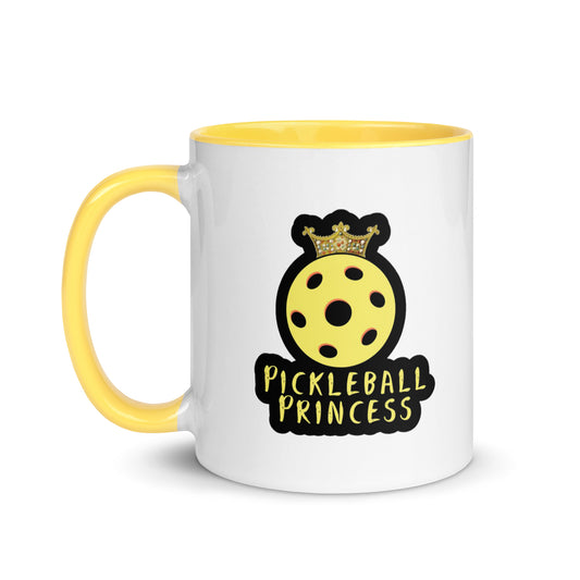 White ceramic mug with a yellow handle displaying the 'Pickleball Princess' design with a crowned yellow pickleball.
