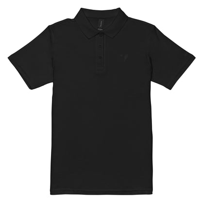 Front view of a black women's pique polo shirt with a minimalist pickleball paddle embroidered in black on the left chest, with the logo on the right sleeve, designed by OOKAMI SPORTS.
