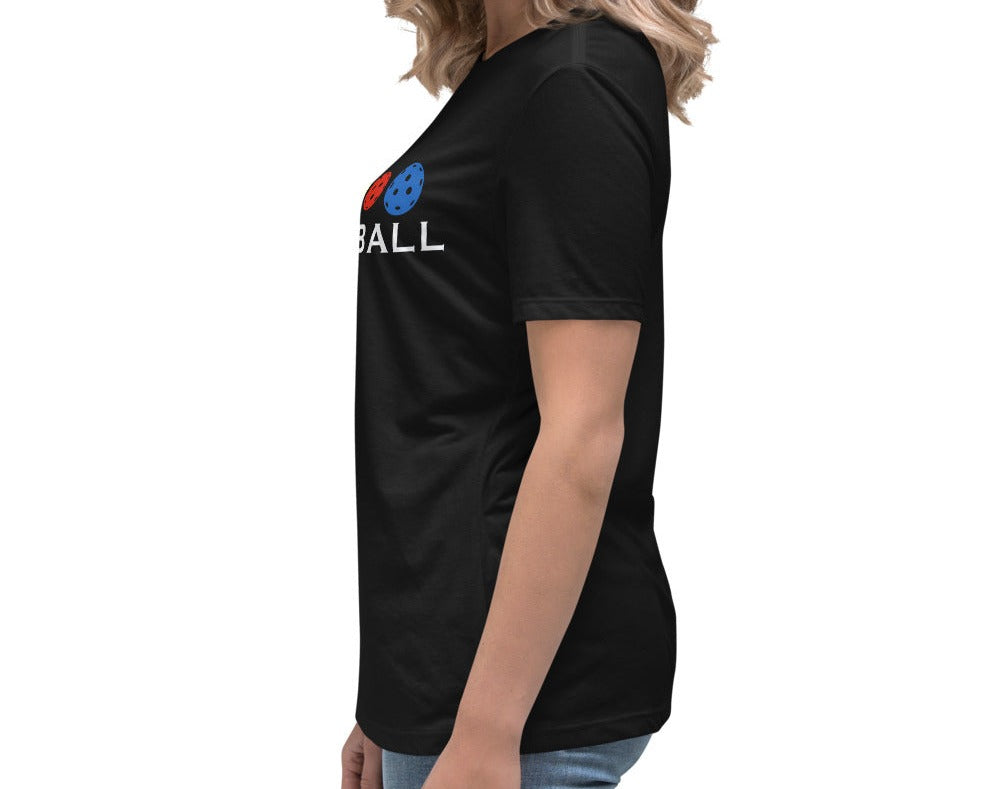 Side view of a woman wearing a black Women's Relaxed T-Shirt with a Colorful Pickleballs design.