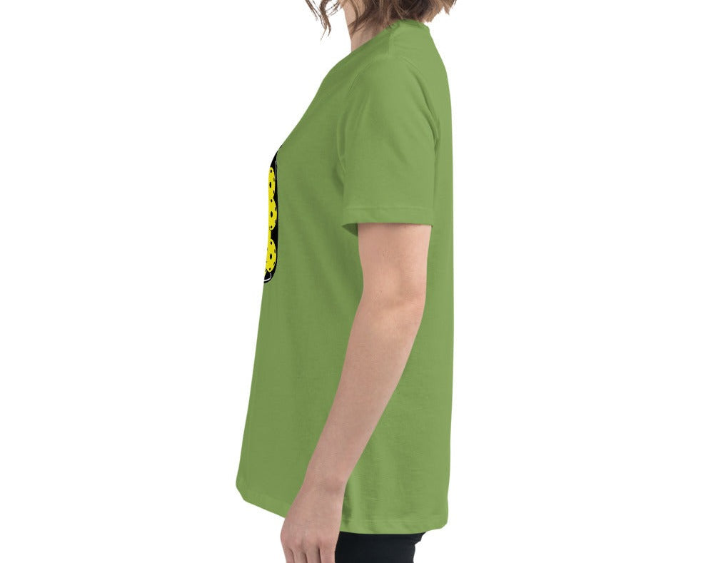 Side view of a woman wearing a leaf green T-shirt with a jar of pickleballs design, showing the left side.