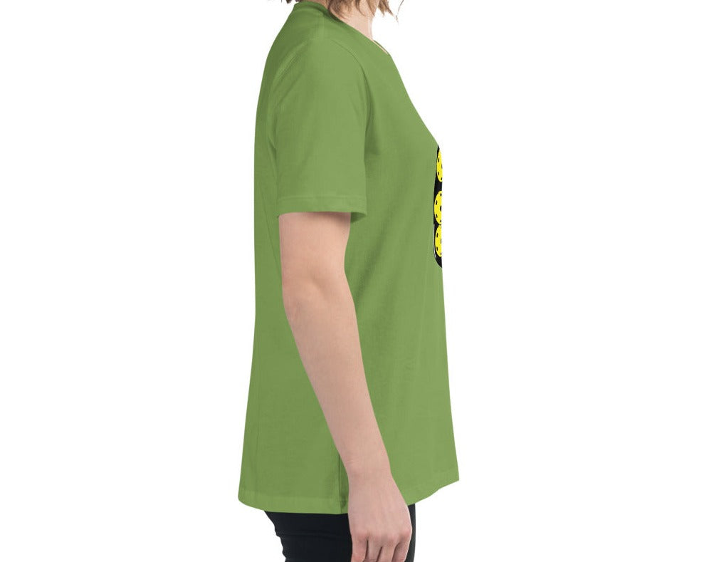 Side view of a woman wearing a leaf green T-shirt with a jar of pickleballs design.