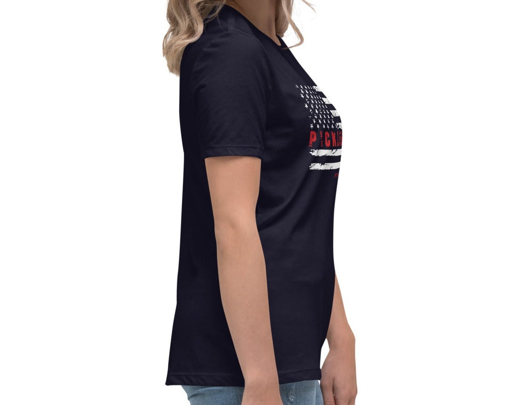 Alternate side view of a woman wearing a navy Women's Relaxed T-Shirt with a USA flag and "Pickleball" design.