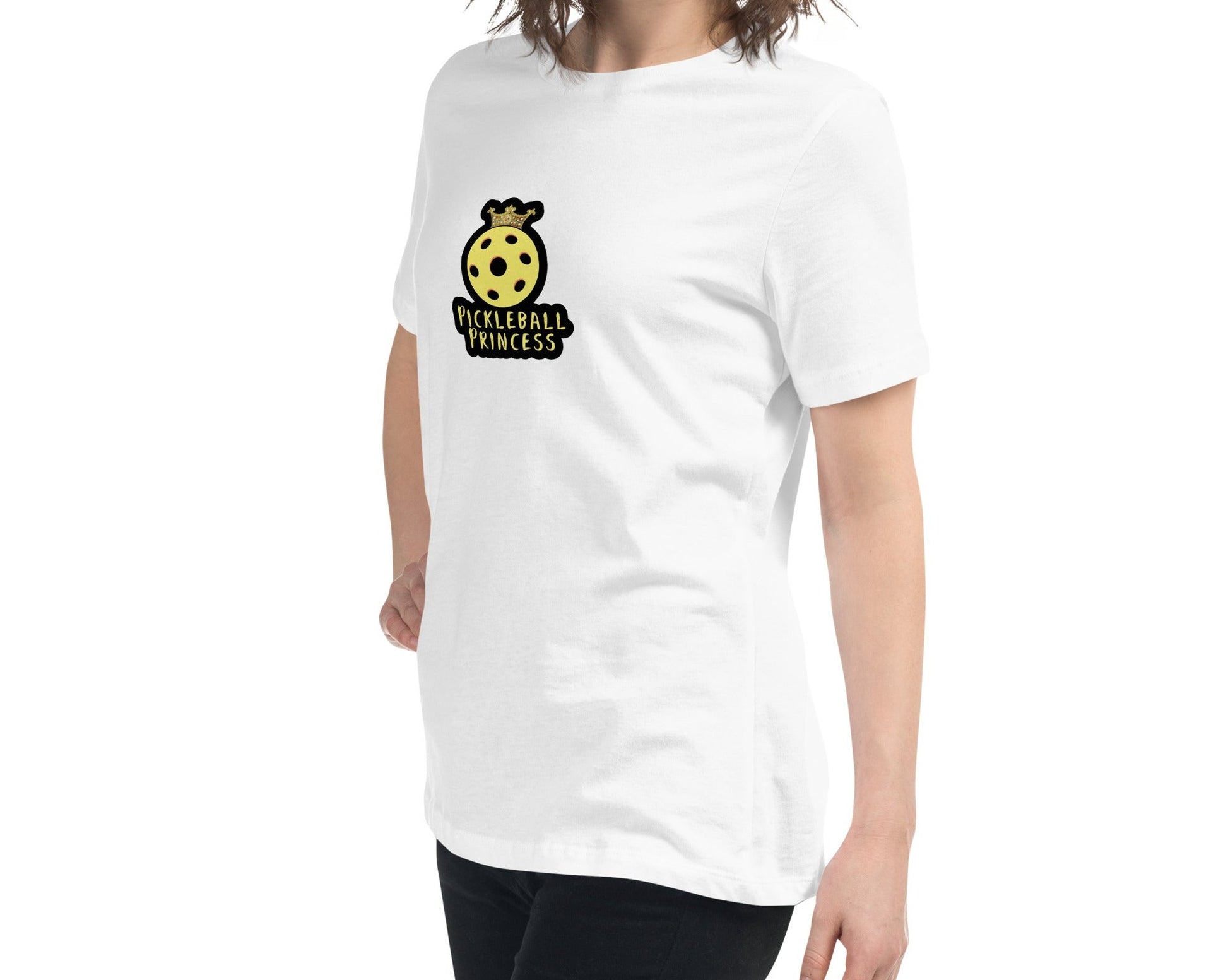 Side view of a woman wearing a white Women's Relaxed T-Shirt with a Pickleball Princess design.